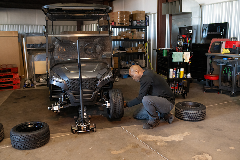 West Valley Golf Cars mechanic changing tire on golf cart